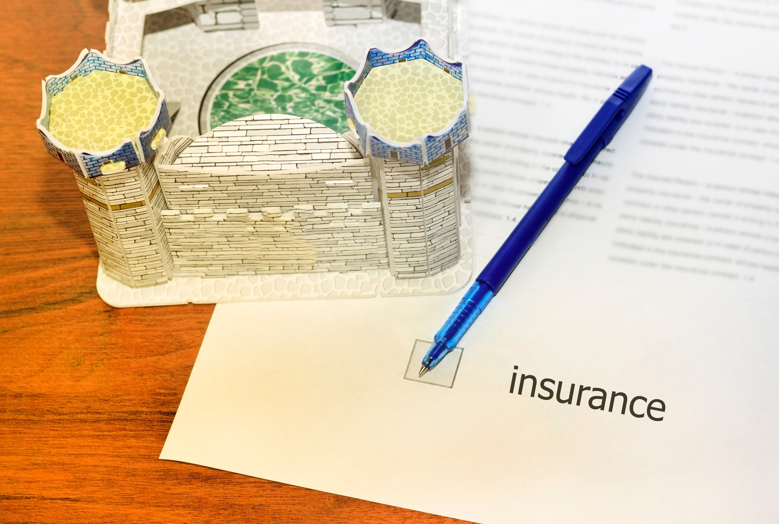 A blue pen rests on a paper labeled